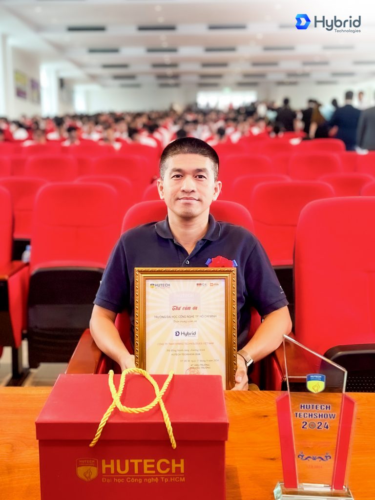[Hình 02 - 03: Đại diện Hybrid Technologies - Anh Huỳnh Kim Long - Delivery Manager Hybrid Technologies Hồ Chí Minh nhận Thư cảm ơn và Kỉ niệm chương từ Nhà trường] 